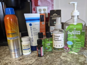 stock pile of basic needs, bug spray, hand santizer, sunscreen, coffee